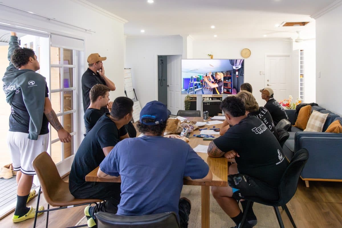 Tommy running a meeting with the Team 247 crew